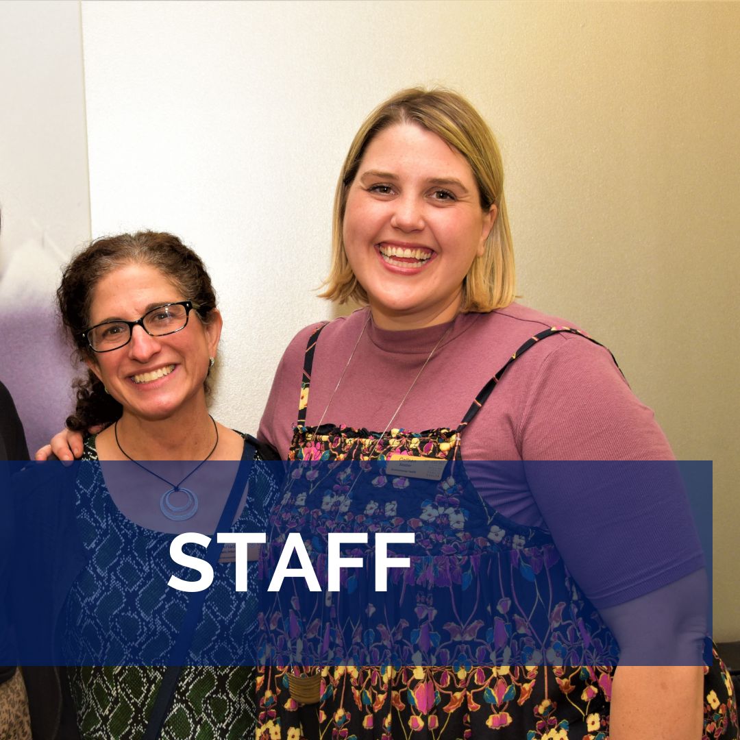 Two department staff smile and pose for a picture.